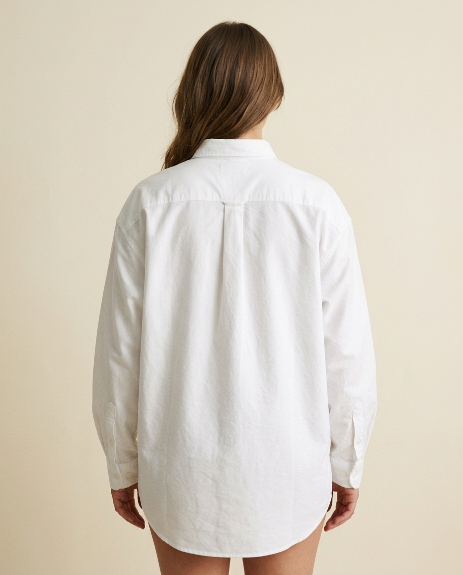 Oversized white Oxford bridal shirt, three-quarter view showing the relaxed borrowed-from-him fit